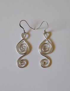 Modern Twist Metal Earrings With Ear Wire, Handmade Swirl Earrings For Gifts, Wire Wrapped Swirl Earrings For Gift, Metal Swirl Earrings With Ear Wire, Handmade Swirl Metal Earrings, Handmade Metal Swirl Earrings, Silver Swirl Wire Wrapped Earrings, Spiral Silver-plated Wire Earrings, Aluminum Jewelry