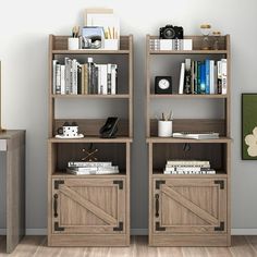 two wooden bookshelves with doors on each side in front of a gray wall