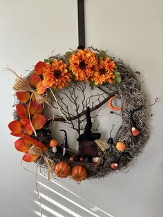 a wreath decorated with pumpkins and other decorations