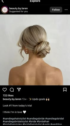 the back of a woman's head with blonde hair in a low bun braid