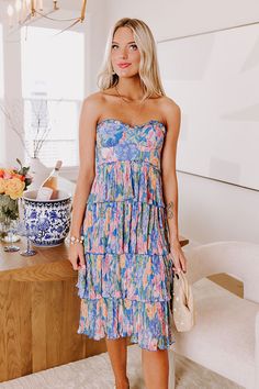 - Step into a whirlwind of charm and whimsy with this dreamy dress! Its strapless cut and tiered skirt bring playful vibes to your look. Whether you are twirling at a garden party or stealing the spotlight at a stylish Sunday brunch, this piece is your ticket to fabulousness! - Fully lined chiffon material with a green, pink, and orange hued floral print - A ruffled strapless neckline with an interior non-slip strip - Back zip closure - Structured boning at the sides of the bodice - Pleated tiers at the skirt - A flowy and flattering silhouette that ends in a straight hemline Strapless Neckline, Dreamy Dress, Chiffon Material, Sunday Brunch, Tiered Skirt, Garden Party, A Garden, Bodice, Floral Print