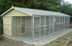 a dog kennel in the middle of a field