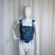 This delicate corset was created for a modern-day fairy princess to help to evoke the magical spirit of your own personal fairy tale. This corset is made from second hand store jeans and cotton flowery shirt. We seek to reduce textile waste and pollution by creating something new from  unusable clothes that end up in a landfill. This corset features: -Corset has back lacing (~2 m of satin ribbon) -The bows on the shoulders can be re-tied to fit perfectly -Corset is fully lined with flower cotton Blue Fitted Corset For Costume Party, Blue Overbust Corset For Costume Party, Blue Corset With Boned Bodice, Blue Overbust Corset For Party, Blue Underbust Corset With Fitted Bodice, Blue Overbust Corset With Boned Bodice, Blue Underbust Corset With Boned Bodice, Blue Overbust Corset Dress For Costume Party, Fairycore Fitted Overbust Corset Dress