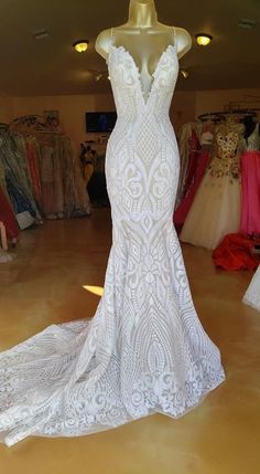 a white wedding dress on display in a store