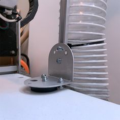 a metal object sitting on top of a white counter next to a heater oven