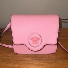 New With Tags And Dust Bag - Bright Pink Versace La Medusa Accordion Bag. Gorgeous Pink Pebbled Calf Leather. Magnet Closure With One Zip Pocket And Two Open Interior Pockets. Will Come With Dust Bag, Strap Is Removable And Adjustable! Fits Biggest Iphone. Luxury Pink Pouch-shaped Satchel, Luxury Pink Pouch Satchel, High-end Pink Crossbody Shoulder Bag, Luxury Pink Formal Flap Bag, Luxury Pink Flap Bag With Removable Pouch, Luxury Pink Flap Bag With Detachable Handle, Designer Pink Flap Bag With Dust Bag, Luxury Pink Clutch Flap Bag, Designer Pink Flap Bag