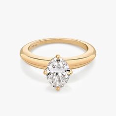 a yellow gold engagement ring with an oval cut diamond