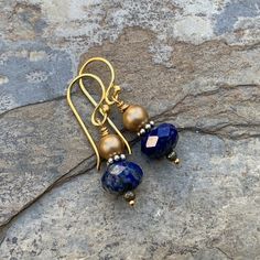 Stunning color combination! These drop earrings feature a faceted a lapis rondelle and a round gold pearl. The addition of sterling silver, vermeil and pyrite really set off the bold blue lapis. Ear wires are vermeil gold. Lapis: 10 x 6mm Pearls: 5mm Your jewelry will arrive in a cotton lined kraft box within a padded postal envelope. I use USPS first class mail. This usually takes 3 to 5 days to ship. International orders outside of the U.S. will take 8 to 15 days to ship. To see more from East Gold Lapis Lazuli Jewelry Set With Earrings, Handmade Yellow Gold Lapis Lazuli Jewelry, Gold Lapis Lazuli Earrings As Gift, Gold Lapis Lazuli Earrings For Gift, Elegant Lapis Lazuli Earrings With Natural Stones, Handmade Gold Lapis Lazuli Earrings, Gold Teardrop Lapis Lazuli Earrings, Gold Lapis Lazuli Drop Earrings, Gold Lapis Lazuli Gemstone Earrings