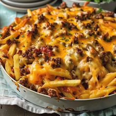 a cheesy casserole dish with meat and cheese on top, ready to be eaten