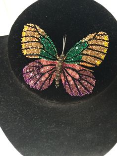 Vintage butterfly brooch pin with colorful rhinestones in pink, gold, and green.  Circa 1990s estate find.  This pin is in excellent condition with NO missing stones and a clasp that works perfectly.  It is gorgeous, feminine, playful, colorful! Use this brooch as a lapel pin, collar pin, hat pin.  There are so many ways to wear a pin and make a statement about who you are.  This butterfly pin is awesome! Thanks for shopping! Jan Multicolor Butterfly Brooch Jewelry, Pin Hat, Rosa Gold, Collar Pin, Butterfly Pin, Collar Pins, Gold And Green, Hat Pin, Butterfly Brooch