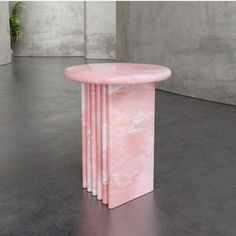 a pink marble table sitting on top of a floor