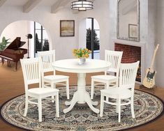 a white table with four chairs and a piano in the background on a round rug