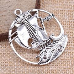 This adorable silver tone  charm is made from zinc alloy metal and is lead and nickel free. It's perfect for crafting necklaces, bracelets, earrings, bookmarks, key chains and more!    ♥ Antique Silver Tone  Pirate Ship Sailboat Charm   ♥ Material: Zinc Alloy Metal   ♥ Size: 43 x 39mm   ♥ Includes: 1 piece    We ship from North Carolina via USPS with tracking included. Tracking is included with all orders.   Get free shipping on orders over $35!  Don't forget to favorite us too, we add items daily.   Thank you... craft on. Silver Metal Round Pendant Charm, Silver Round Pendant Charms, Nickel-free Metal Round Pendant Charms, Nickel Free Round Metal Pendant Charms, Silver Round Metal Charms, Nickel-free Round Metal Pendant Charm, Charms For Jewelry Making, Pirate Ship, Diy Charms