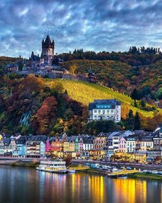 a castle on top of a hill next to a body of water