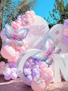 balloons are arranged in the shape of letters and butterflies