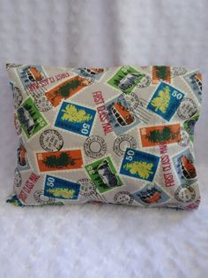 a pillow that has stamps all over it