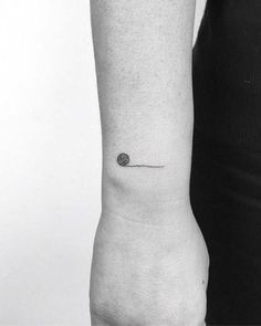 a person with a small tattoo on their arm