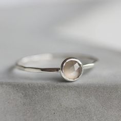 This refined silver ring with Gray Moonstone is a wonderful piece for a unique one. It is deep and mysterious, making up a perfect addition to your outfit.The ring is 1 mm thick and is very sturdy although it looks very dainty on the finger. The stone is 5 mm in diameter, rose cut.Choose the  material for the ring (sterling silver or 9k gold).You can order a ring of any size. If you are not sure about your size, this might be helpful: findmyringsize.comIf you want to buy the ring as a gift and y Silver Faceted Moonstone Ring In Sterling Silver, Elegant Everyday Silver Moonstone Ring, Minimalist Silver Moonstone Ring In Sterling Silver, Silver Minimalist Stackable Rings With Bezel Setting, Silver Stackable Rings With Bezel Setting, Minimalist Silver Stackable Rings With Bezel Setting, Delicate Silver Stackable Rings With Birthstone, Silver Moonstone Stackable Rings, Silver Moonstone Stackable Rings With Birthstone