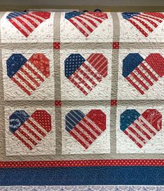 an american flag quilt with hearts on it