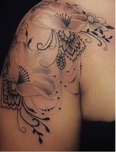 the back of a woman's shoulder with flowers on it