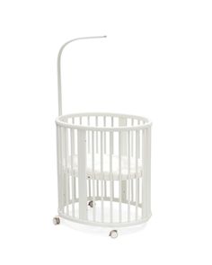 a white baby crib with wheels on it