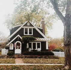 a black and white house in the fall