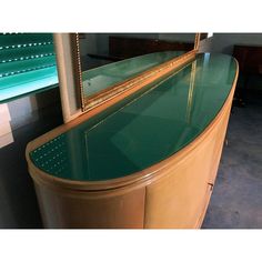 a green counter top sitting next to a mirror