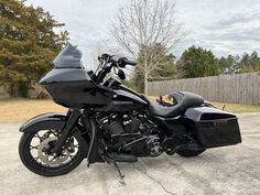 a black motorcycle parked in a parking lot