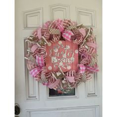 a pink and brown wreath on the front door