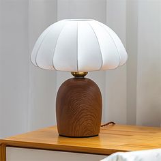 a wooden table with a white lamp on it