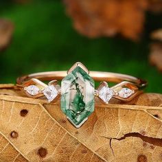 a close up of a ring on top of a leaf