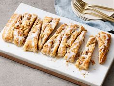 a white cutting board topped with sliced up pastry