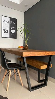 a wooden table sitting next to two black chairs