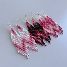 three pairs of pink and white beaded earrings