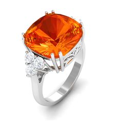 Product Details The Engagement Ring is elegantly adorned with Cushion Cut Lab Created Orange Sapphire secured by Double Prong Setting and Round Diamond Trio studded on either side of the center stone. Whether its a day plan or a night out with your girls, our Created Orange Sapphire Ring will never disappoint you. Product Information SKU SHP-RINGS062310115 Weight 3.44 gm (Approximate) LAB CREATED ORANGE SAPPHIRE INFORMATION No.of Stones 1 Pieces Total Weight 9.00 Carat (Approximate) Dimension(approx) Cushion-12X12 mm-1 Pcs Color Orange Cut Brilliant Shape Cushion Setting Type Prong-Setting Quality Grade AAAA DIAMOND INFORMATION No.of Stones 6 Pieces Total Weight 0.54 Carat (Approximate) Dimension(approx) Round-2.40X2.40 mm-6 Pcs Color HI Cut Brilliant Shape Round Setting Type Prong-Setting Sapphire Oval Engagement Ring, Orange Sapphire Ring, Fire Opal Engagement Ring, Oval Engagement Ring, Cushion Cut Engagement, Cushion Cut Engagement Ring, Oval Engagement, Opal Engagement, Stunning Engagement Ring