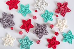 crocheted ornaments are arranged on a white surface