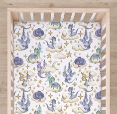 a baby crib sheet with dragon and stars on it