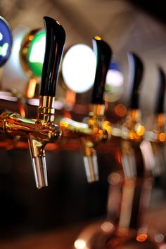 a row of beer taps in a bar