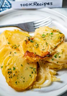 a white plate topped with ravioli and potatoes