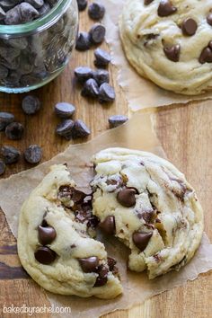 two chocolate chip cookies on a piece of parchment paper