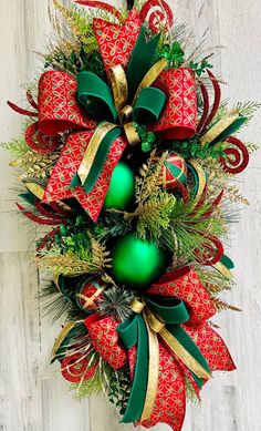 a christmas wreath with green and red ornaments