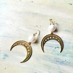 Natural pearls and Moon earrings. Elegant Gold Earrings With Moon Charm, Elegant White Crescent Earrings, Elegant Crescent Moon Charm Earrings, Elegant Half Moon Earrings With Moon Charm, Elegant Moon Charm Drop Earrings, Gold Crescent Earrings With Moon Phase Detail, Elegant White Moon Charm Earrings, Elegant Brass Earrings With Moon Charm, Gold Moon Phase Earrings