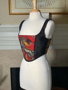 Over-bust corset with flexible boning and black lacing in back.  Red dragon cotton, flanked by black velvet and flame print cotton with faux leather in the back. Sizing is pretty flexible because of lace-up closure. Just choose the size that you feel is closest and I will make the corset specifically to your measurements. Message me if you have questions!  Mannequin's measurements - Waist: 27" Bust: 37" Generally here are the sizes, but I will modify it to fit you based on your bust and waist me Dragon Corset, Embroidery Corset, Dragon Rouge, Dragon Embroidery, Fashion Timeline, Velvet Corset, Fantasy Costumes, Red Dragon, Corsets