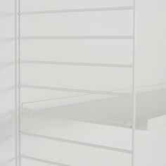 there is a white shelf with two shelves on it and no one in the room