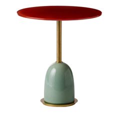 a red and green table with a gold base on white backgrounge background