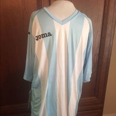 a blue and white soccer jersey hanging on a wooden door with the name jona written on it