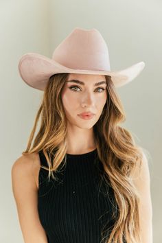 Ummm.... YES!! A timeless and on trend cowboy hat that’s crafted in a ivory faux suede with a coordinating rhinestone band wrapped around. Meet the Kenny Cowboy Hat. The crown is stiffened and shaped into a clean and ridged design. Hand made by artisans, incredible quality, faux suede, lined with satin underneath. The best part? It's super structured with an elastic band on the inside that will fit EVERYONE. THE HAT:-Cowboy style hat, faux suede-Stiff brim with elastic hat band on the inside-Gor Trendy Fedora Hat Bands For Ranch, Trendy Fitted Hat Bands For Rodeo, Western Beige Felt Hat, Western Beige Felt Hat One Size, Trendy Felt Hat For Country Events, Trendy Curved Brim Felt Hat For Rodeo, Trendy Fedora For Rodeo With Short Brim, Western Style Felt Hat For Ranch In Spring, Trendy Fedora With Short Brim For Rodeo