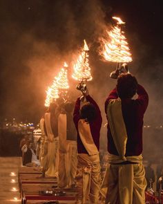 some people are standing around with torches in their hands