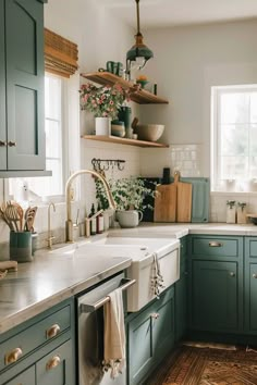 a kitchen filled with lots of green cabinets and white counter top space next to a window