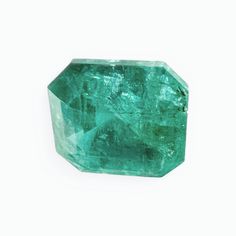 a green emerald stone on a white background